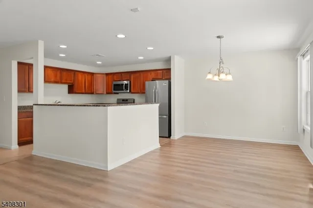 a view of kitchen with cabinets and wooden floor
