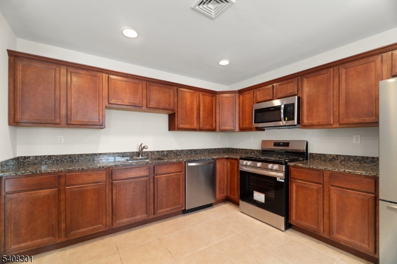 19 Winding Way Hamburg, NJ 07419 - Photo 3 of 16 a kitchen with stainless steel appliances granite countertop wooden cabinets a stove top oven a sink and dishwasher
