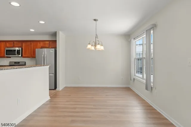 a view of kitchen with granite countertop cabinets and wooden floor
