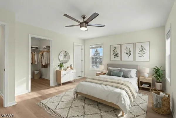 a bedroom with a large bed and a chandelier