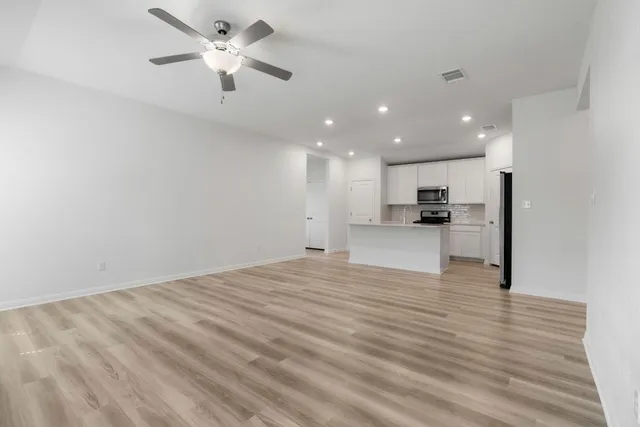 a view of a kitchen with a sink and a refrigerator