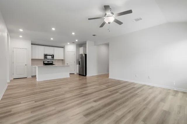 a view of a kitchen with a sink and a refrigerator