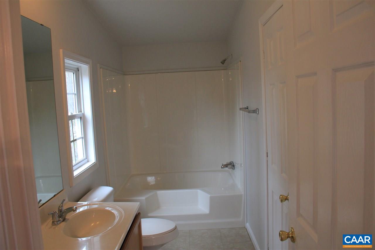 15 Begonia Road Ruckersville, VA 22968 - Photo 8 of 23 a bathroom with a granite countertop toilet a sink and bathtub
