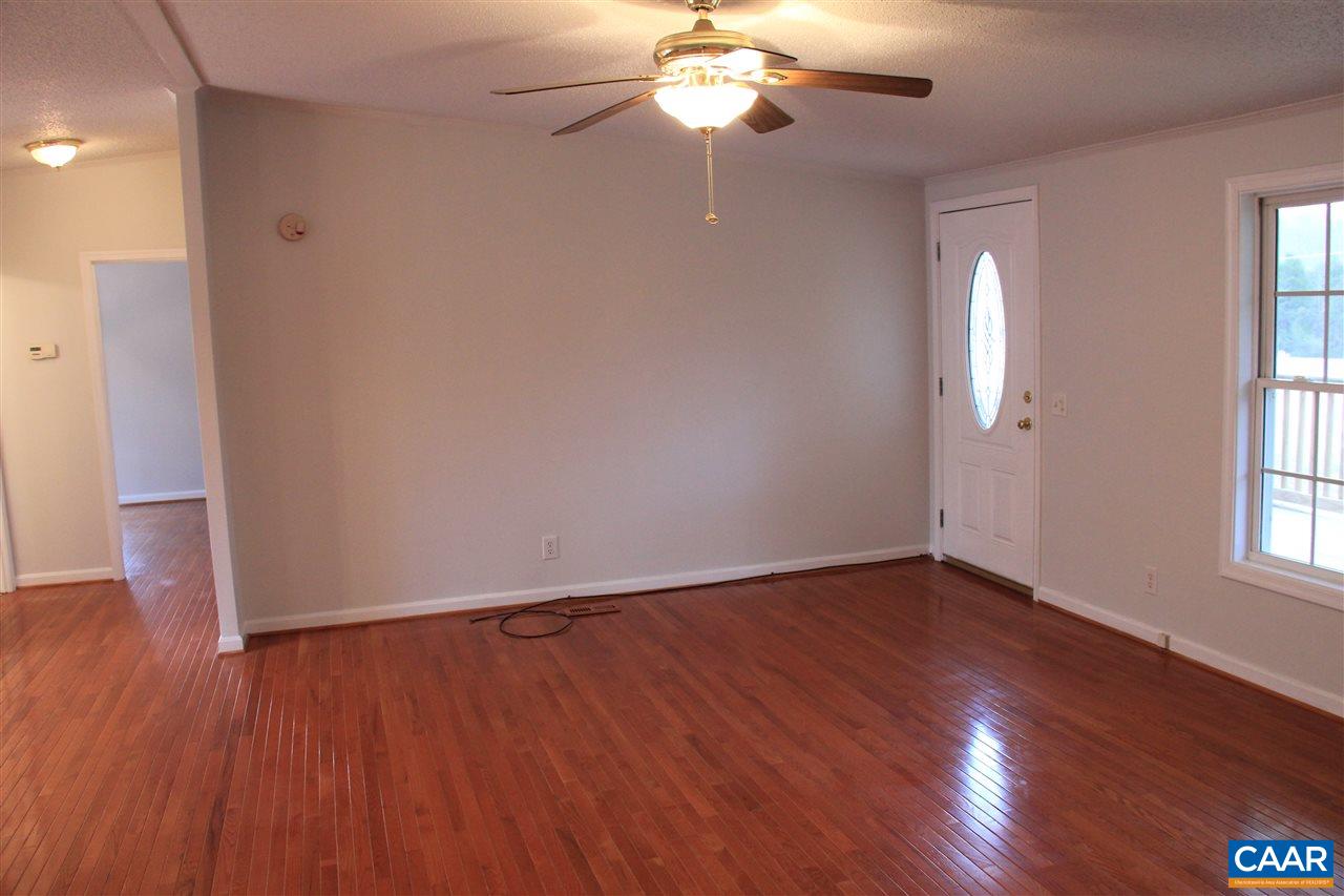 15 Begonia Road Ruckersville, VA 22968 - Photo 9 of 23 an empty room with wooden floor chandelier fan and windows