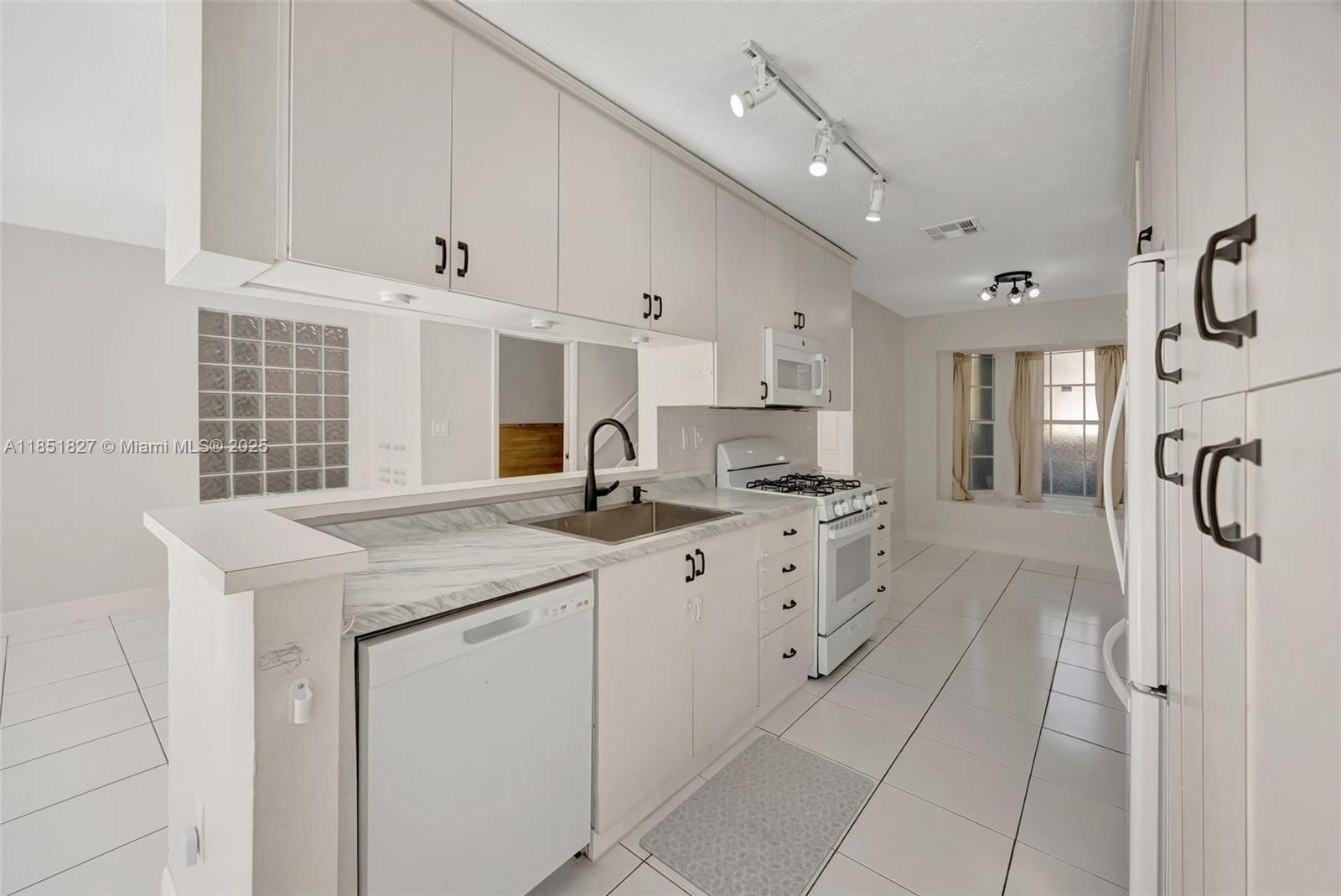 15224 Southwest 111th Street Miami, FL 33196 - Photo 11 of 27 a kitchen with cabinets appliances and a counter
