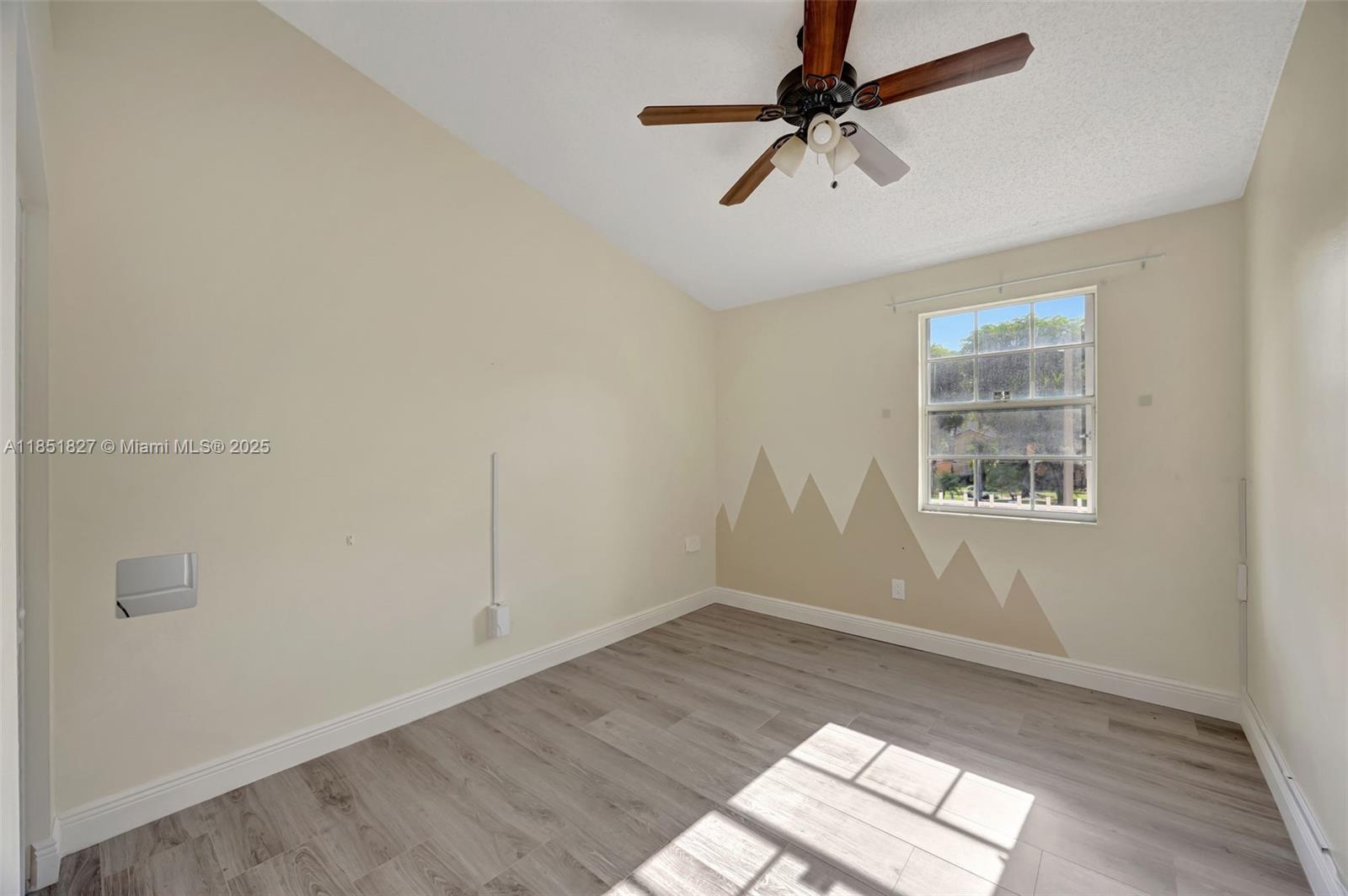 15224 Southwest 111th Street Miami, FL 33196 - Photo 16 of 27 a view of empty room with wooden floor and fan