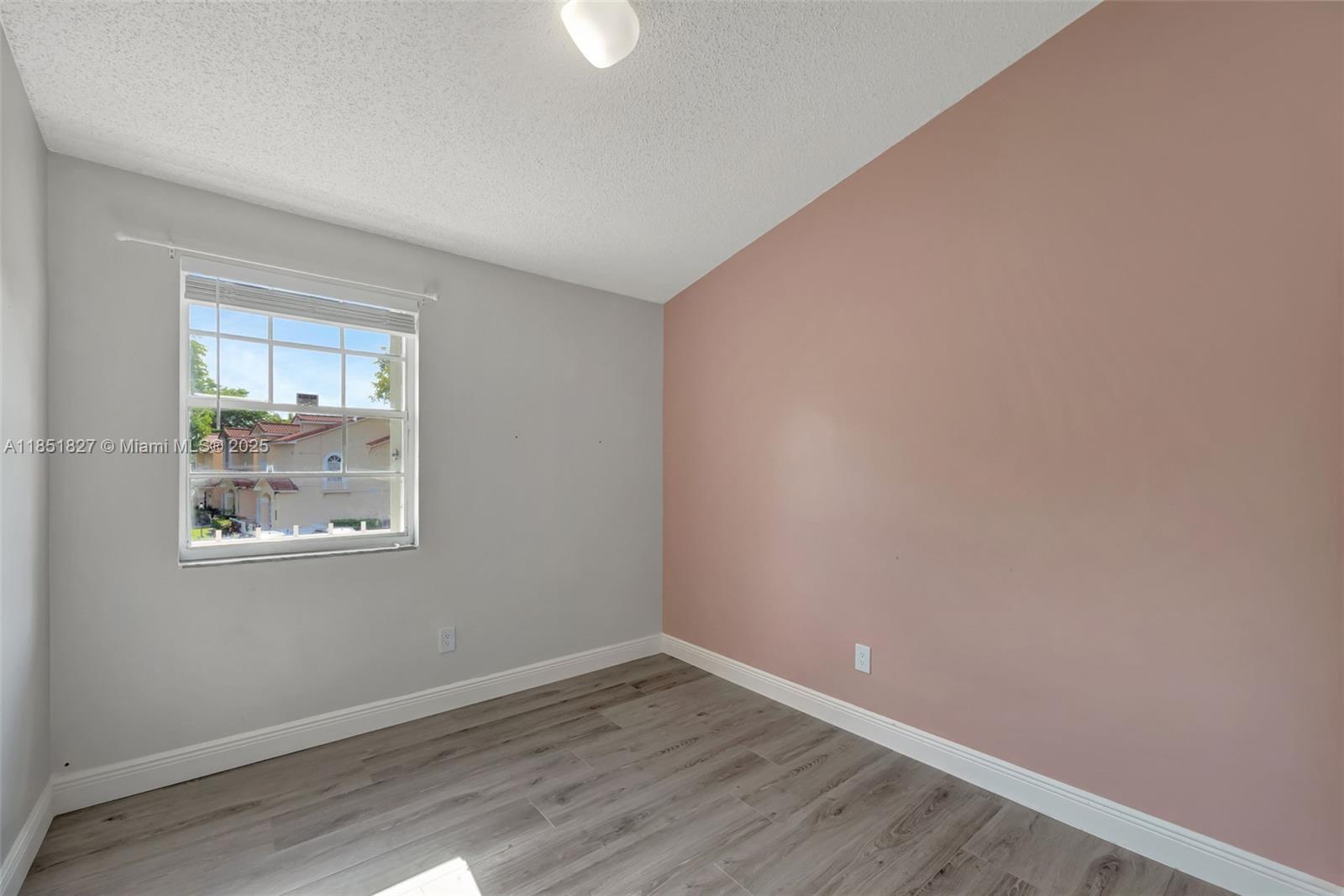 15224 Southwest 111th Street Miami, FL 33196 - Photo 18 of 27 wooden floor in an empty room with a window