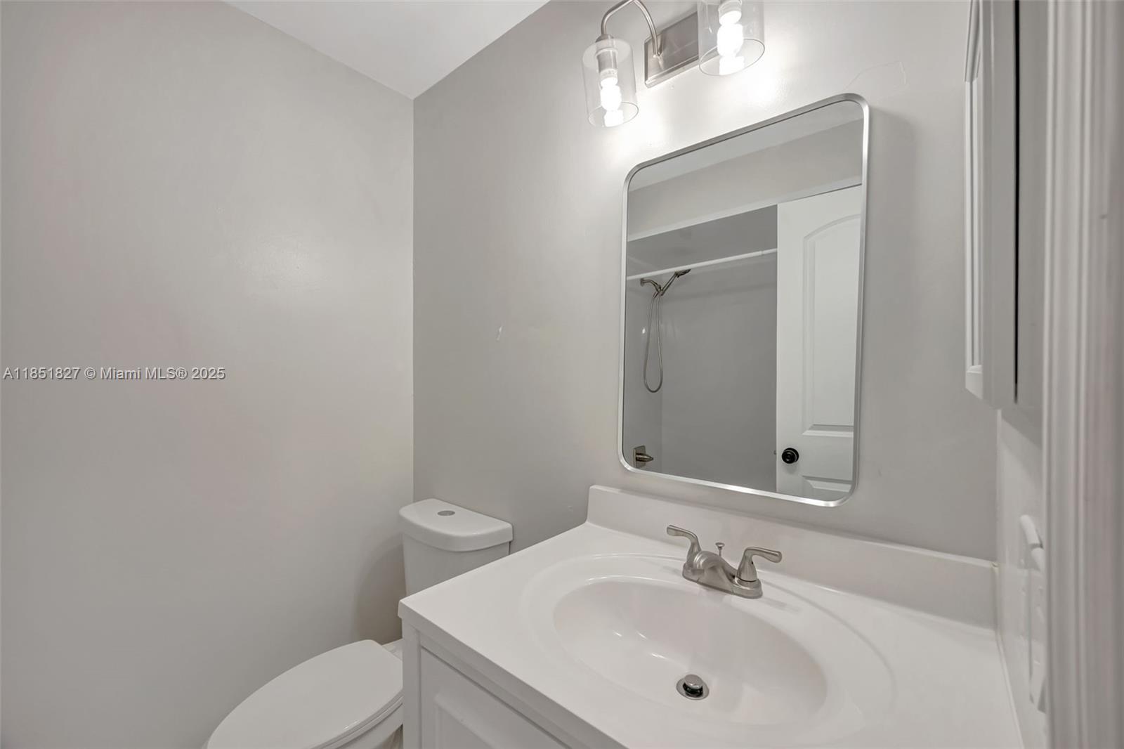 15224 Southwest 111th Street Miami, FL 33196 - Photo 20 of 27 a bathroom with a sink a toilet and mirror