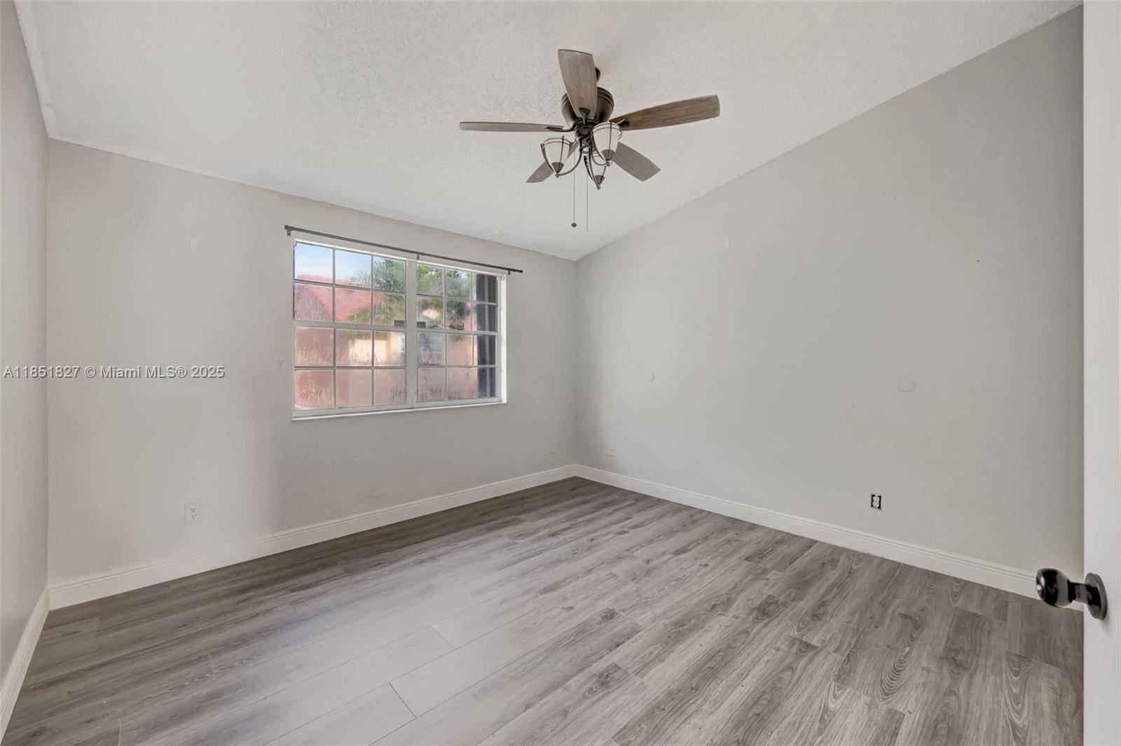 15224 Southwest 111th Street Miami, FL 33196 - Photo 22 of 27 wooden floor in an empty room with a window
