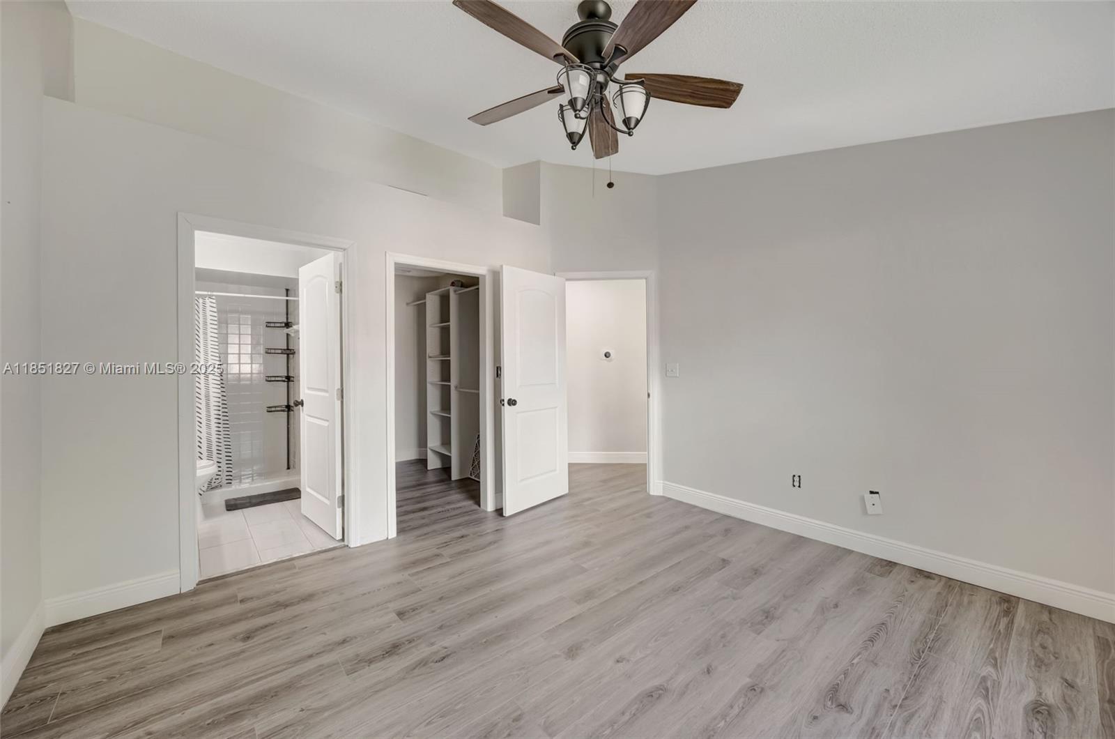 15224 Southwest 111th Street Miami, FL 33196 - Photo 23 of 27 wooden floor in an empty room with a window