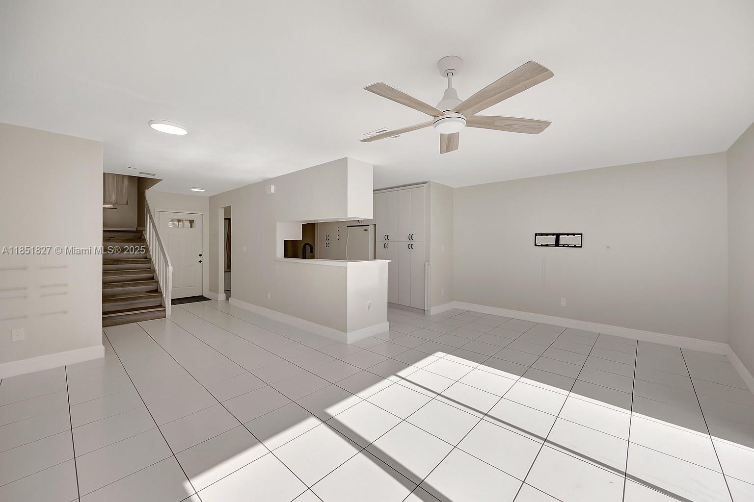 15224 Southwest 111th Street Miami, FL 33196 - Photo 7 of 27 a view of a livingroom with a staircase