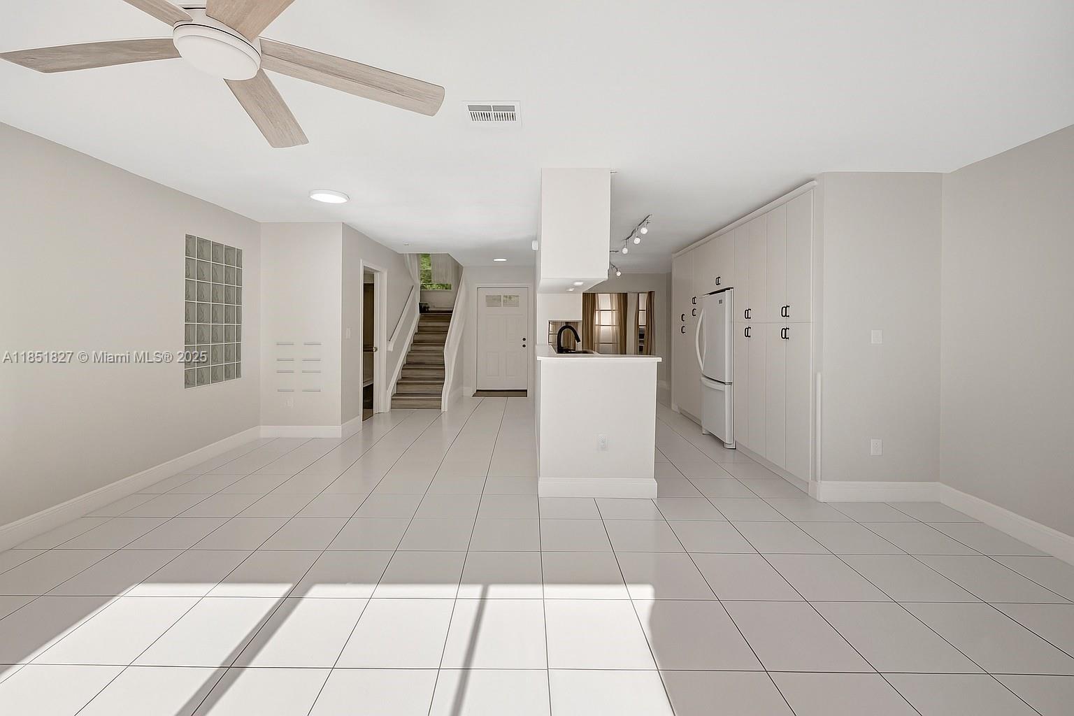 15224 Southwest 111th Street Miami, FL 33196 - Photo 8 of 27 a living room with stainless steel appliances furniture and a kitchen view