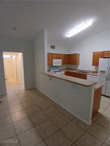 a kitchen with stainless steel appliances a sink and a microwave