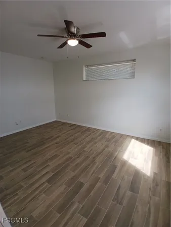 a view of a room with wooden floor and fan