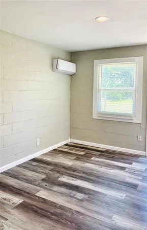 a view of a livingroom with wooden floor and a window