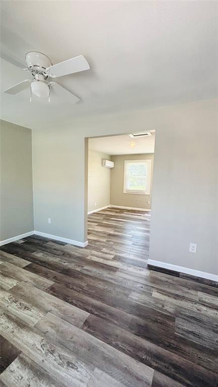 260 South Corinth St Road, Unit 238 Dallas, TX 75203 - Photo 5 of 14 Living room view into bedroom featuring a ceiling fan and dark wood finished floors