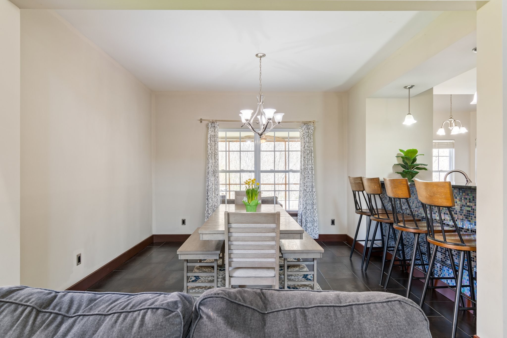 7245 Riverfront Drive Nashville, TN 37221 - Photo 14 of 74 a living room with furniture a chandelier and a dining table