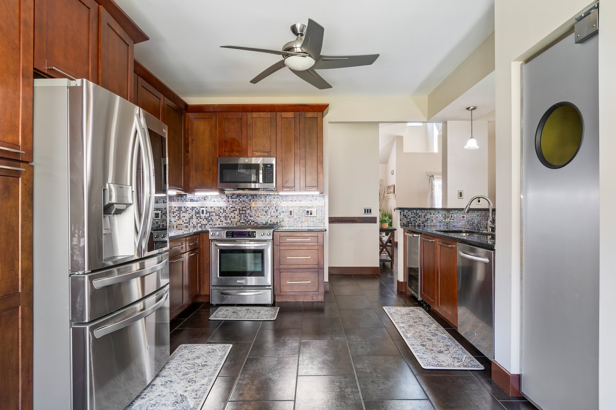 7245 Riverfront Drive Nashville, TN 37221 - Photo 21 of 74 a kitchen with stainless steel appliances granite countertop a refrigerator a stove and a sink