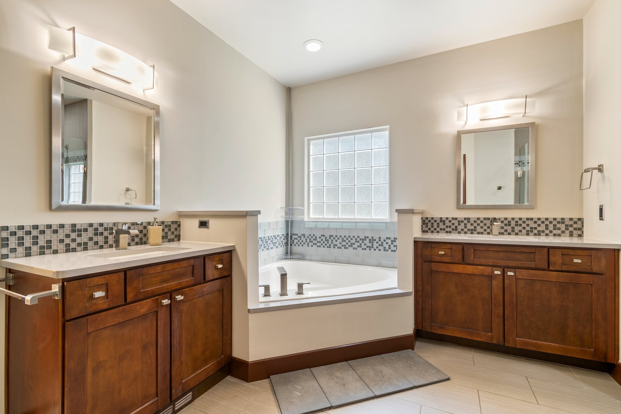 7245 Riverfront Drive Nashville, TN 37221 - Photo 39 of 74 a bathroom with a tub sink and mirror
