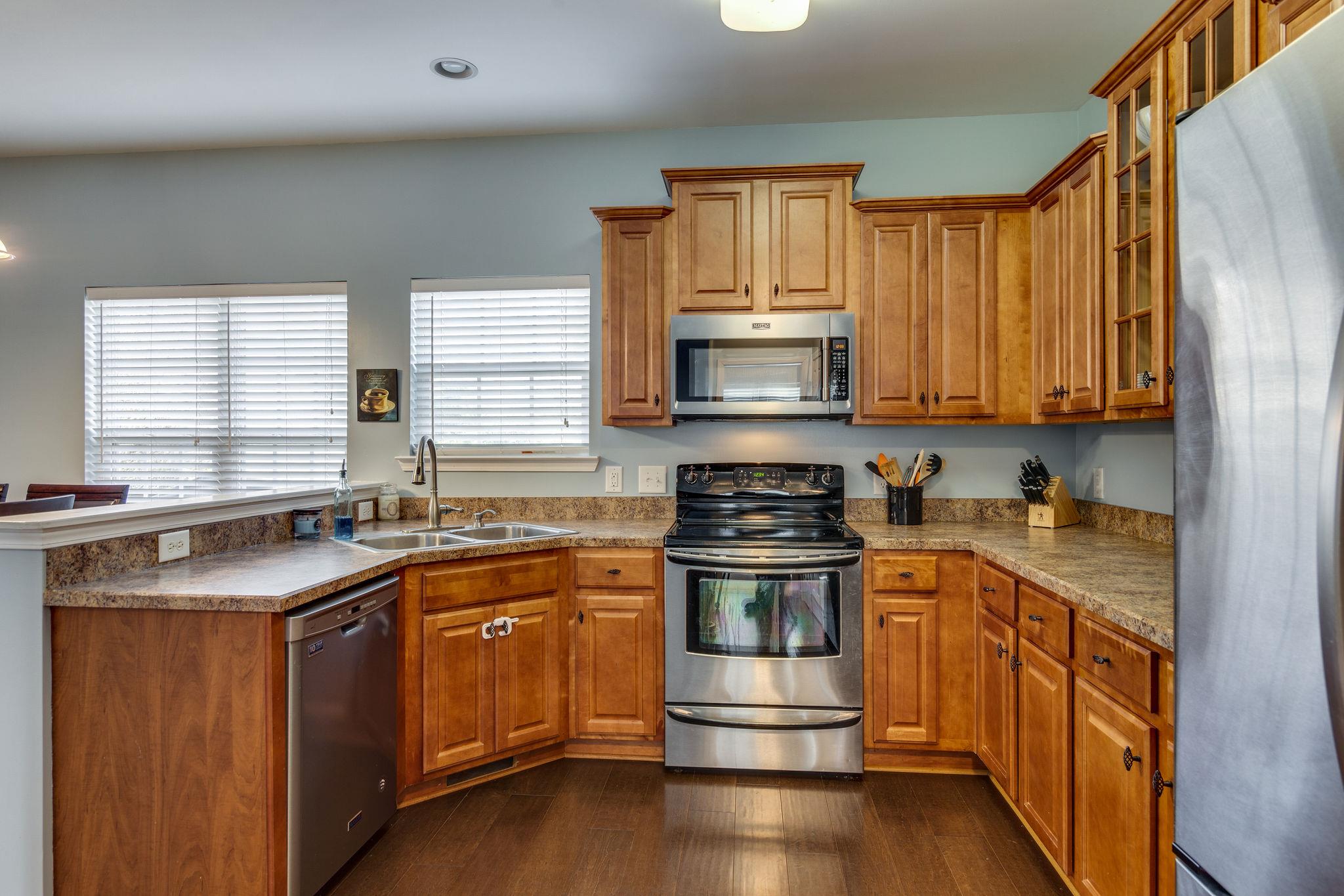 1509 Callender Road Spring Hill, TN 37174 - Photo 12 of 30 a kitchen with stainless steel appliances a stove a sink and cabinets