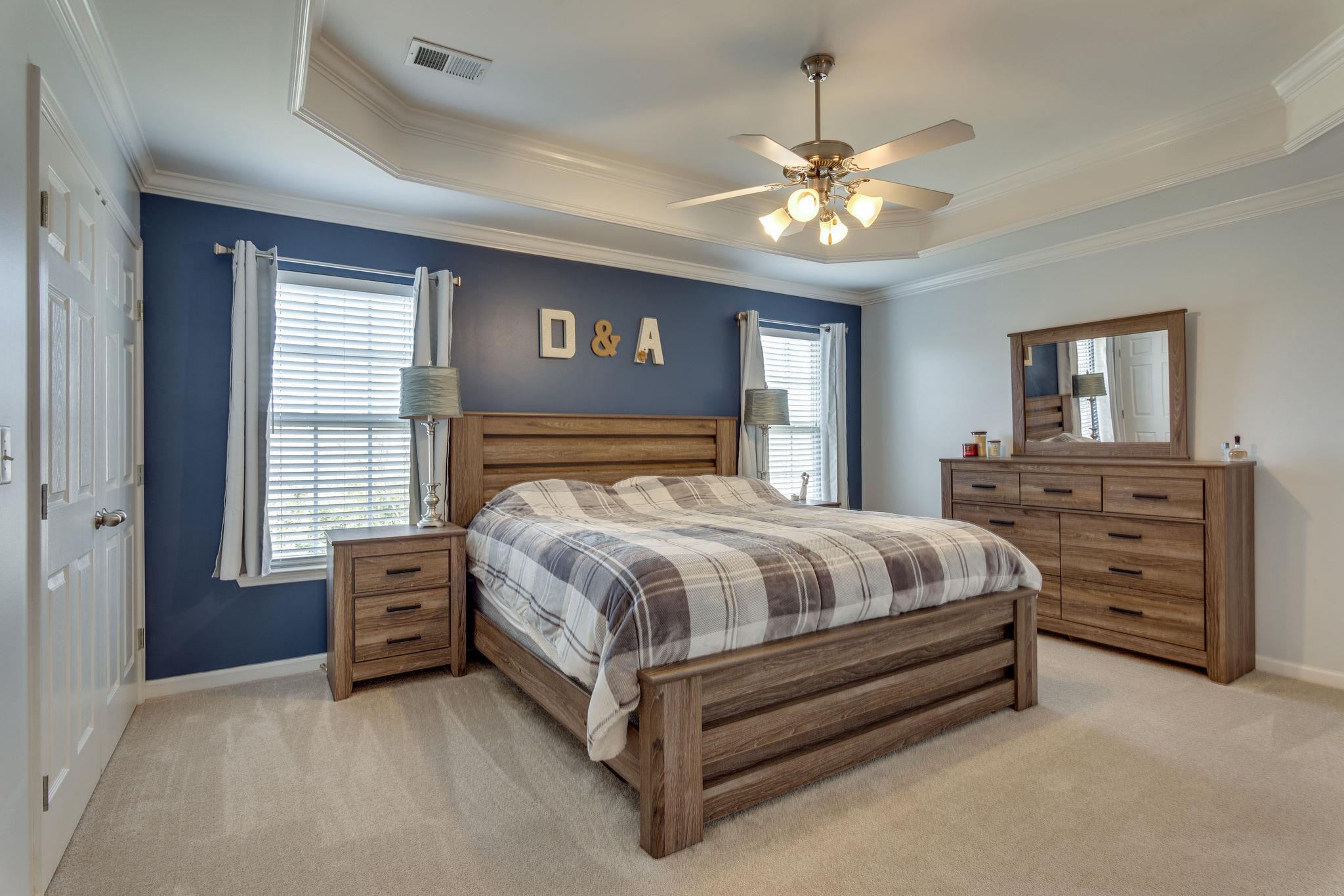 1509 Callender Road Spring Hill, TN 37174 - Photo 16 of 30 a spacious bedroom with a bed and a chandelier