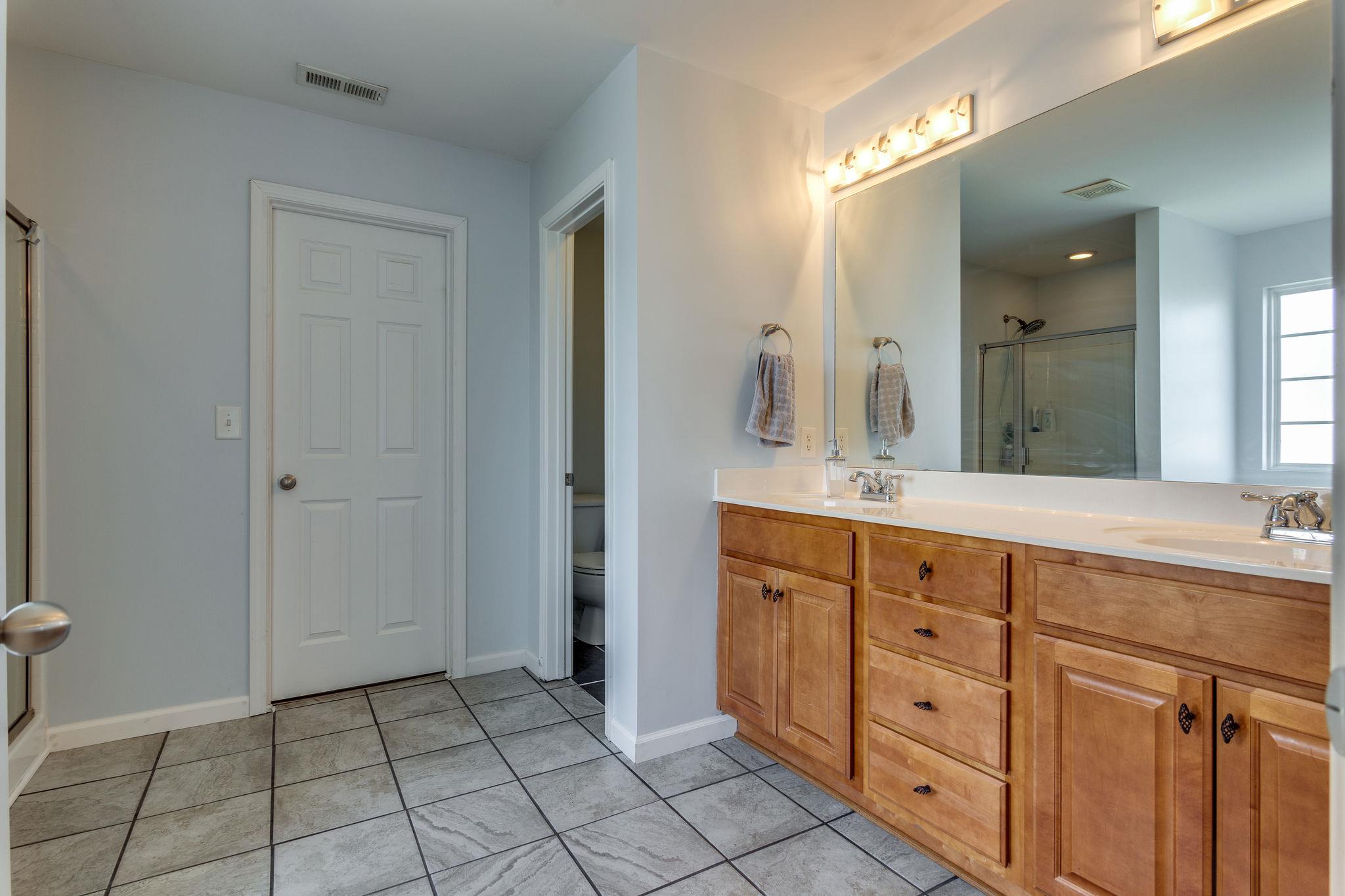 1509 Callender Road Spring Hill, TN 37174 - Photo 17 of 30 a spacious bathroom with a granite countertop sink mirror and