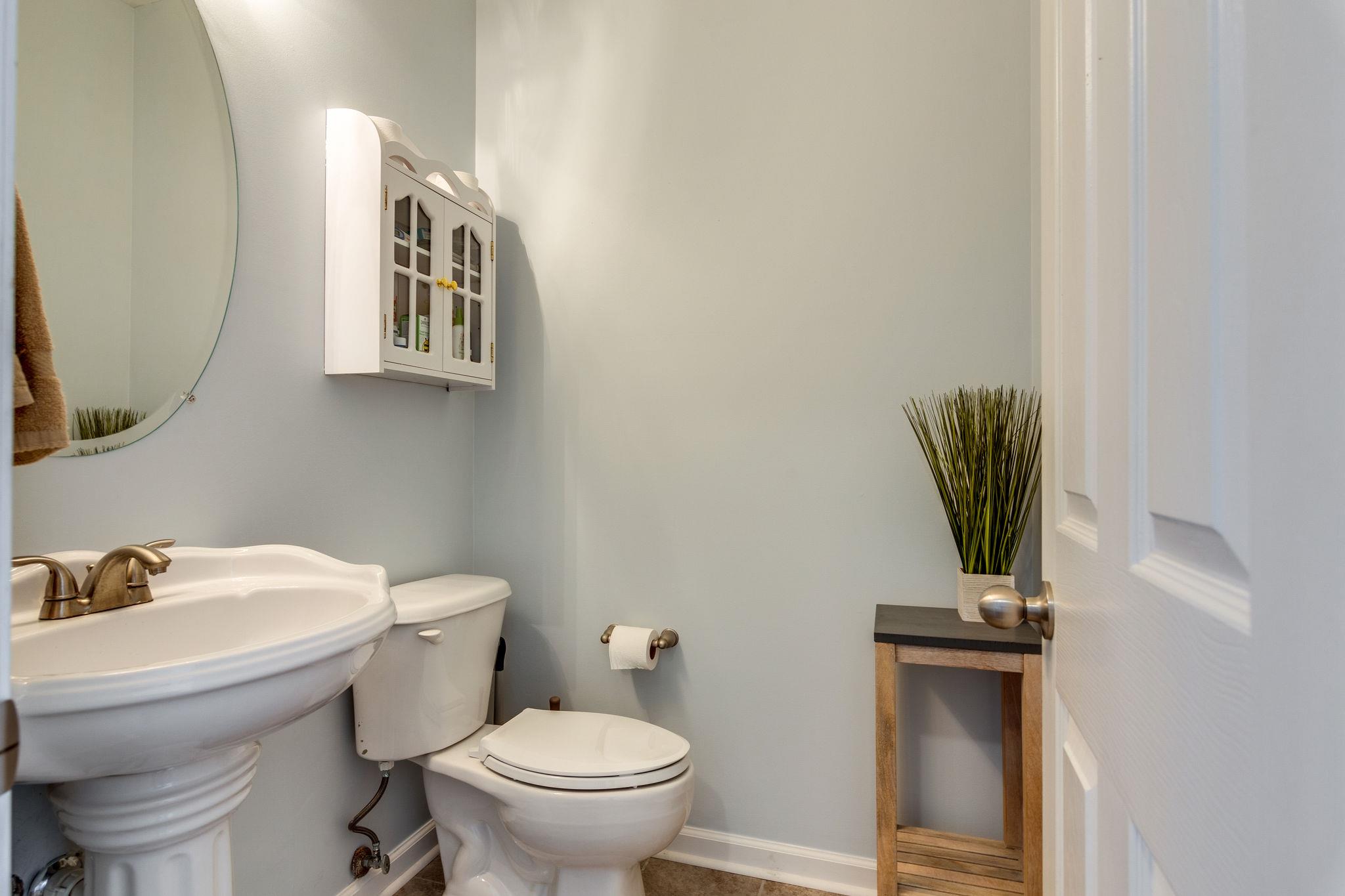 1509 Callender Road Spring Hill, TN 37174 - Photo 7 of 30 a bathroom with a toilet a sink and mirror