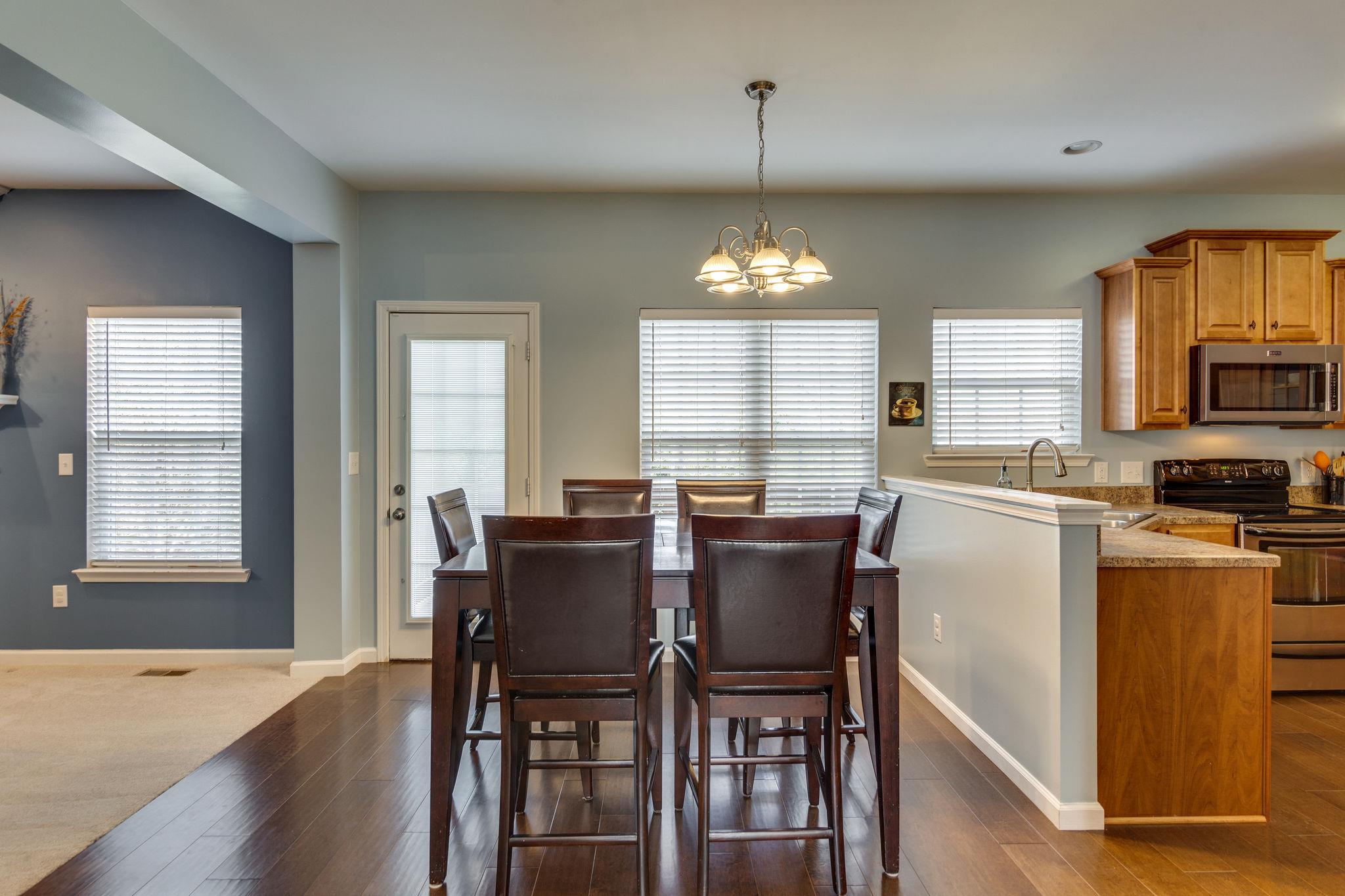1509 Callender Road Spring Hill, TN 37174 - Photo 9 of 30 a view of a dining room with furniture windows and wooden floor