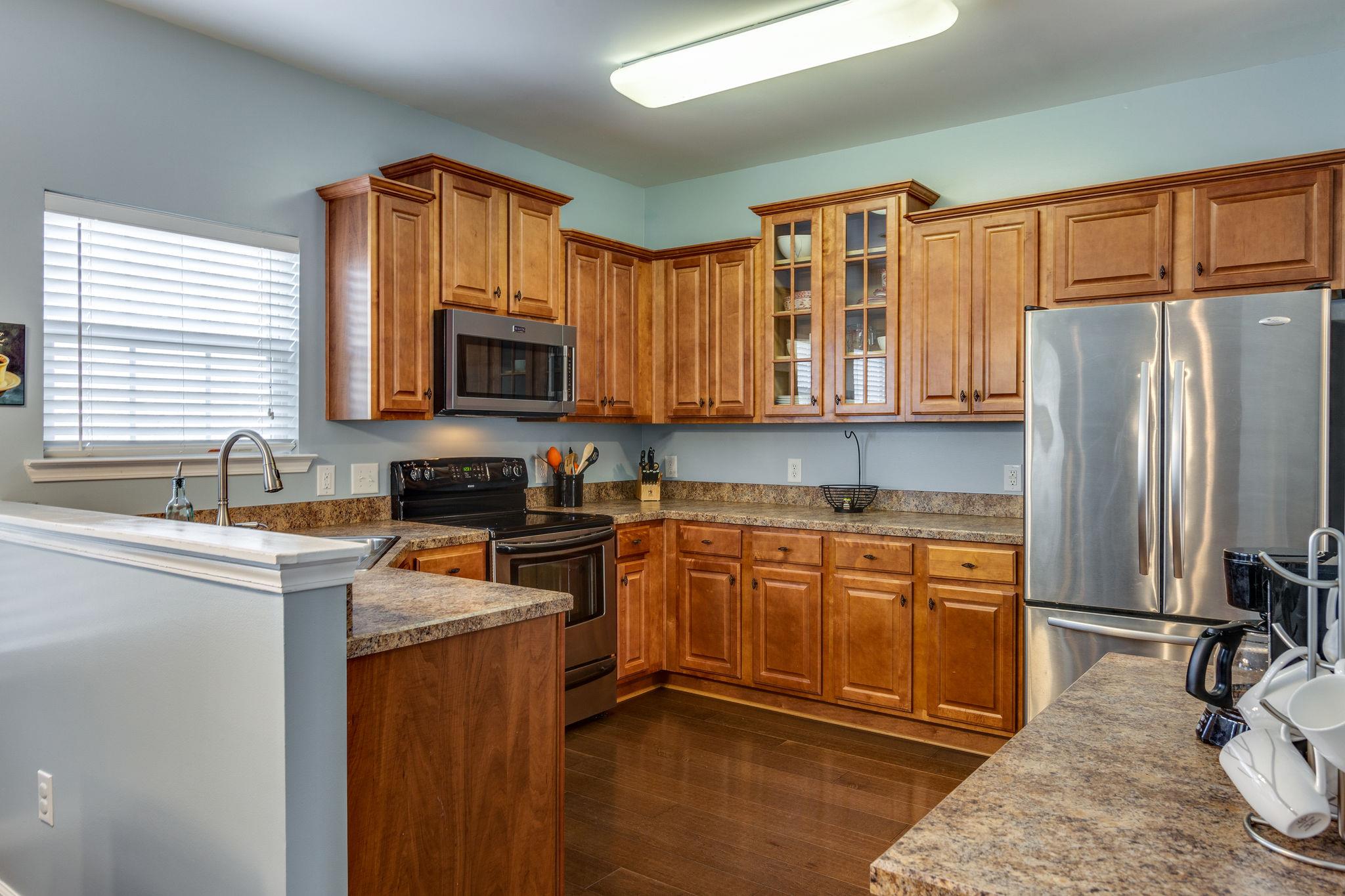 1509 Callender Road Spring Hill, TN 37174 - Photo 10 of 30 a kitchen with stainless steel appliances granite countertop a refrigerator stove top oven a sink and dishwasher