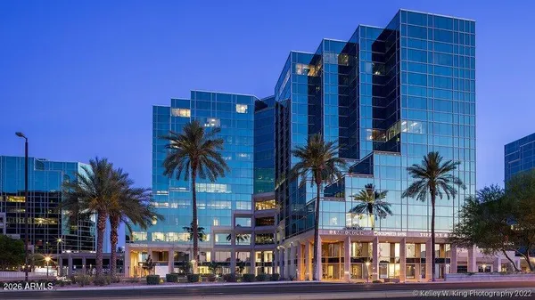 front view of a building with palm trees