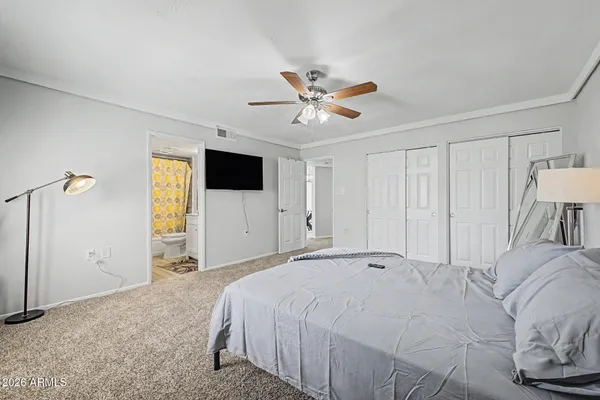 a bedroom with a large bed and a flat screen tv