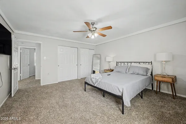 a spacious bedroom with a bed and a table in it