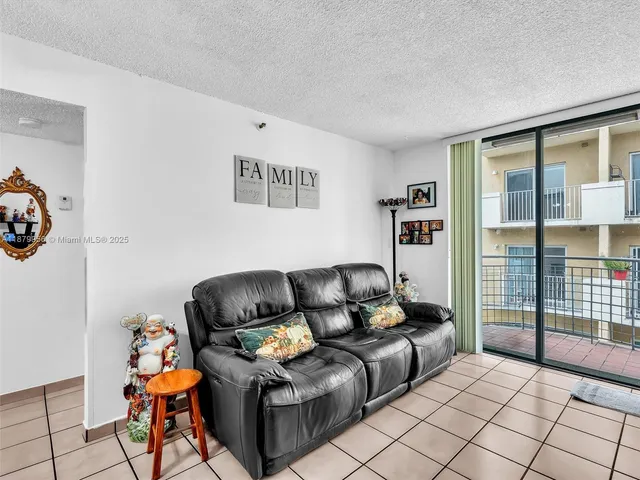 a living room with furniture a rug and a window