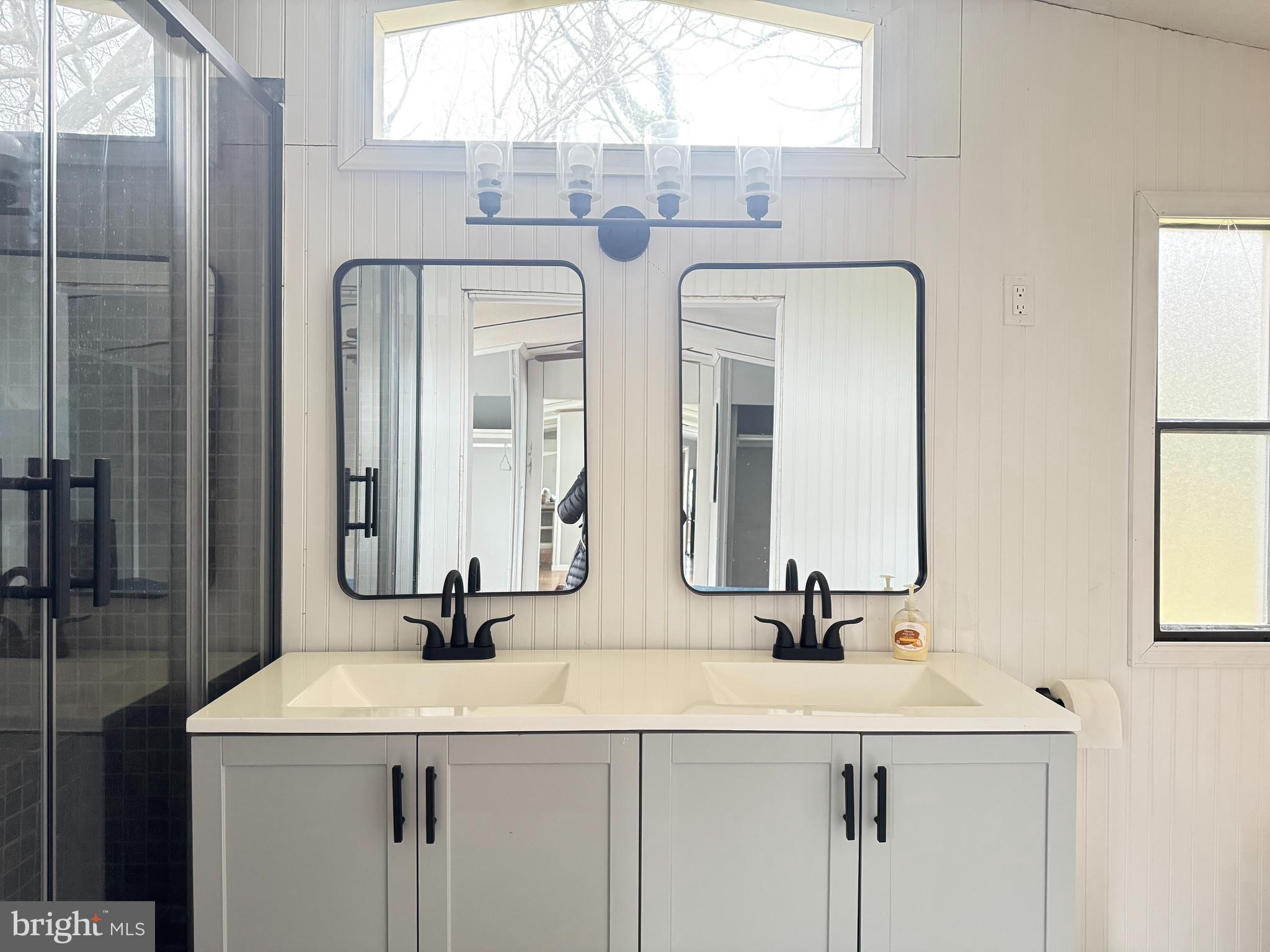 819 Leswood Court Dundalk, MD 21222 - Photo 7 of 18 a bathroom with double vanity sinks and a mirror