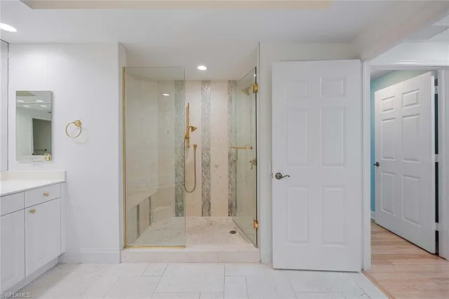 a bathroom with a bathtub a mirror a sink and vanity