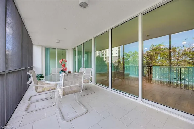 a view of a chairs and table in a balcony