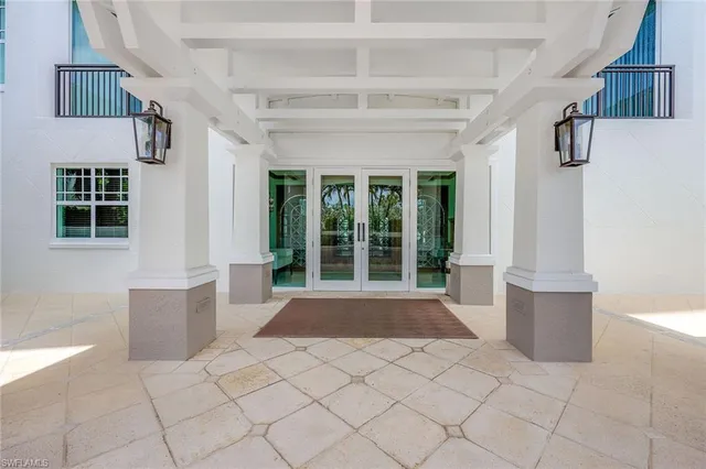 a dining room with furniture and a chandelier