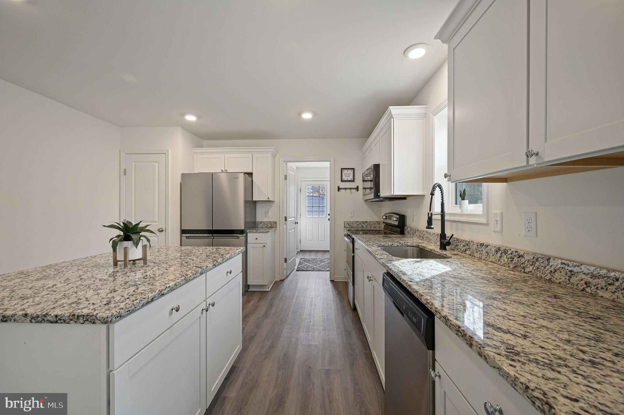4 Senator Avenue Dover, DE 19901 - Photo 13 of 26 a kitchen with stainless steel appliances granite countertop a sink stove and refrigerator
