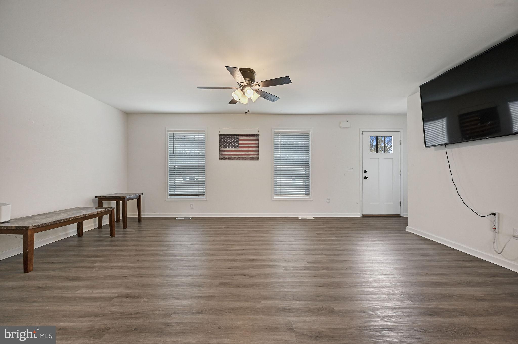 4 Senator Avenue Dover, DE 19901 - Photo 17 of 26 a view of an empty room with wooden floor and a ceiling fan