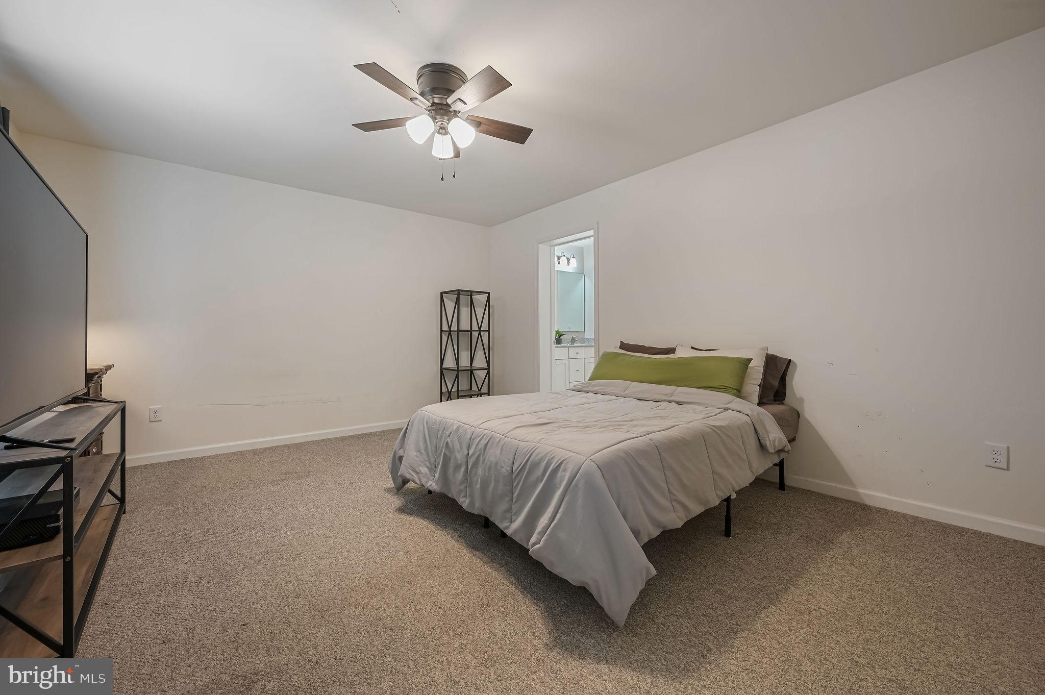 4 Senator Avenue Dover, DE 19901 - Photo 18 of 26 a bedroom with a bed and a chandelier