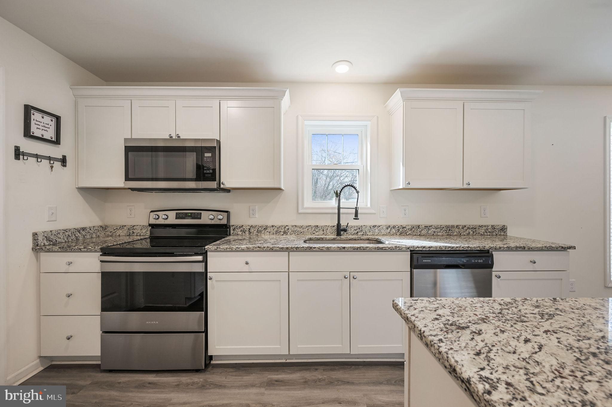 4 Senator Avenue Dover, DE 19901 - Photo 5 of 26 a kitchen with a stove and a microwave