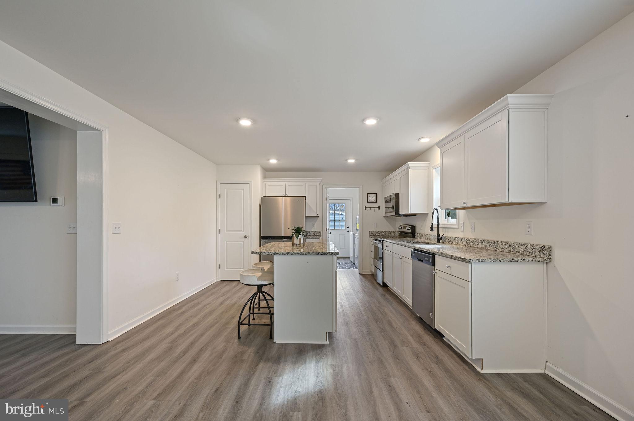 4 Senator Avenue Dover, DE 19901 - Photo 7 of 26 a kitchen with a refrigerator a stove top oven a sink dishwasher and wooden floor