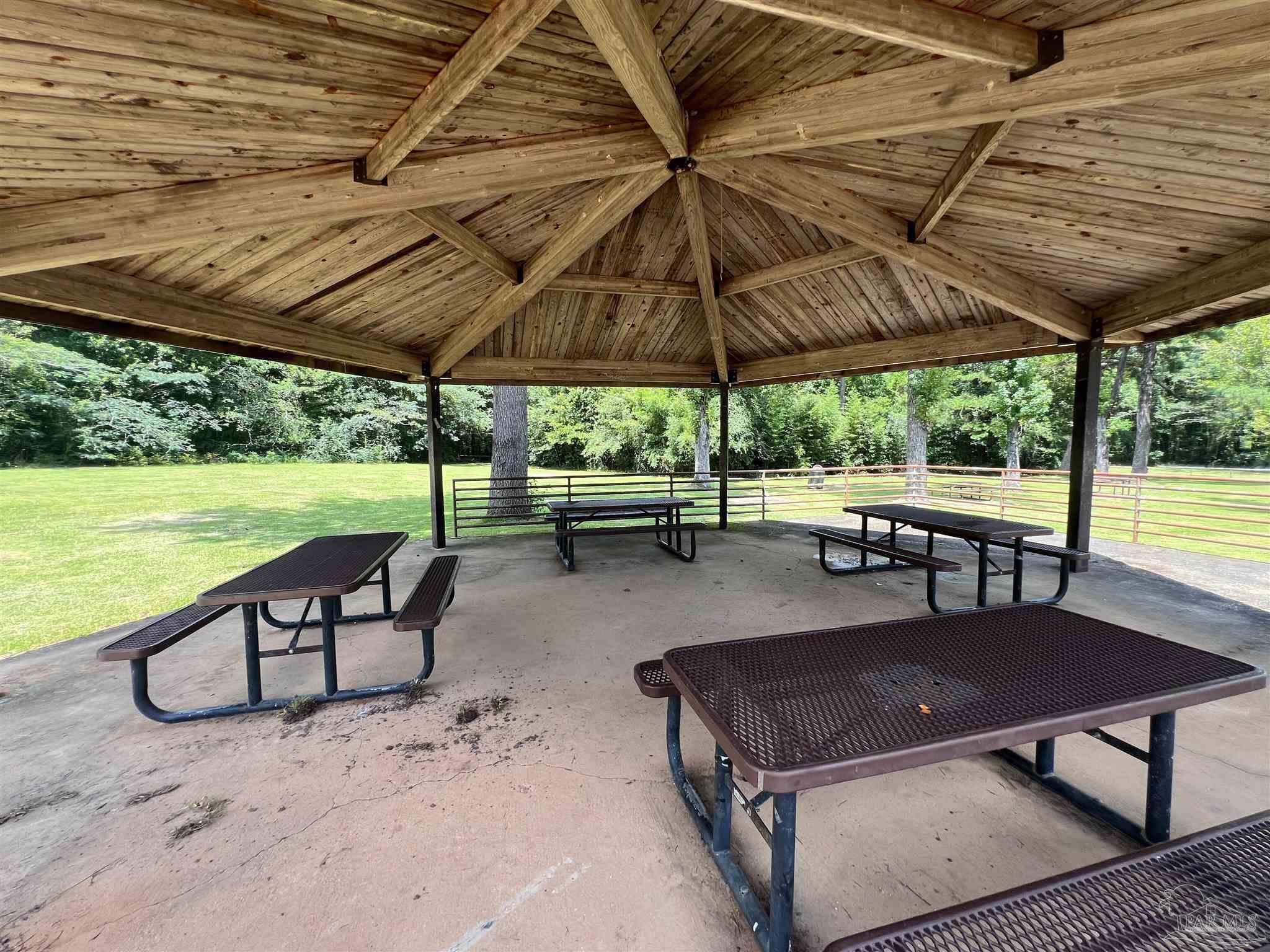 1100 McKinnonville Road Molino, FL 32577 - Photo 12 of 14 a backyard view with a table and chairs under an umbrella