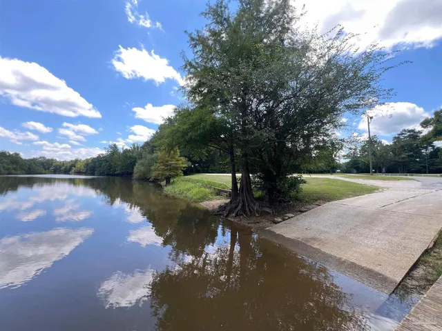 a view of balcony with wooden floor and fence