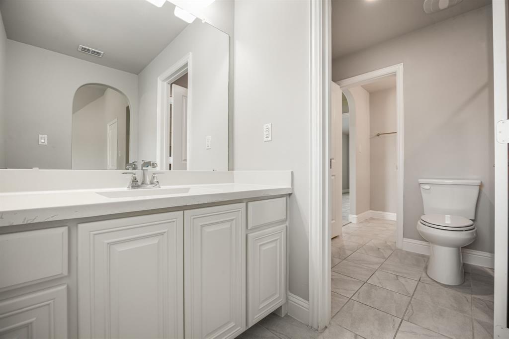 1506 Mariners Hope Way Wylie, TX 75098 - Photo 28 of 39 a bathroom with a toilet a sink a vanity and mirror