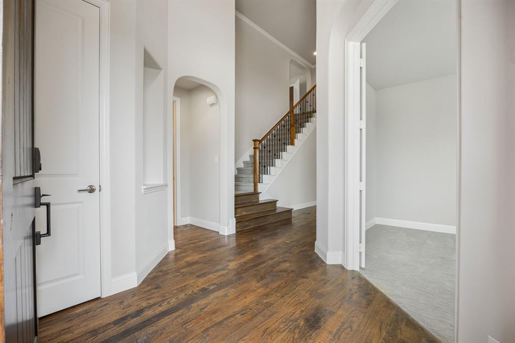 1506 Mariners Hope Way Wylie, TX 75098 - Photo 5 of 39 a view of a hallway with wooden floor and entryway