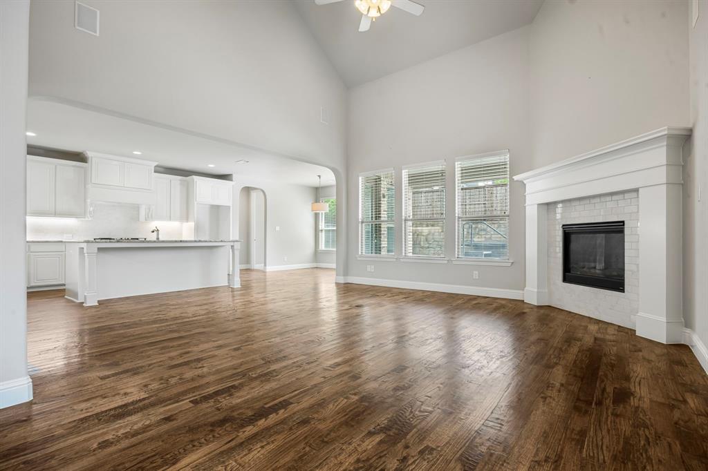 1506 Mariners Hope Way Wylie, TX 75098 - Photo 10 of 39 a view of an empty room with window and wooden floor