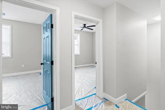 a view of a hallway with wooden floor and closet