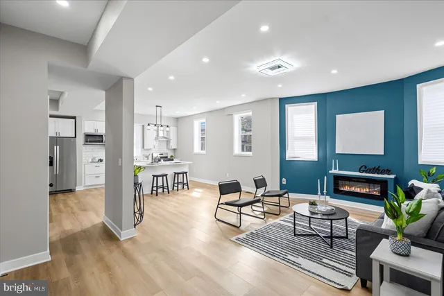a living room with furniture and a dining table with kitchen view