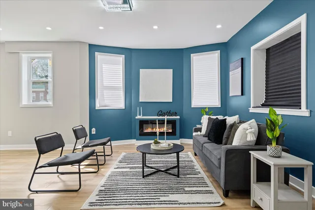 a living room with furniture a rug and a fireplace
